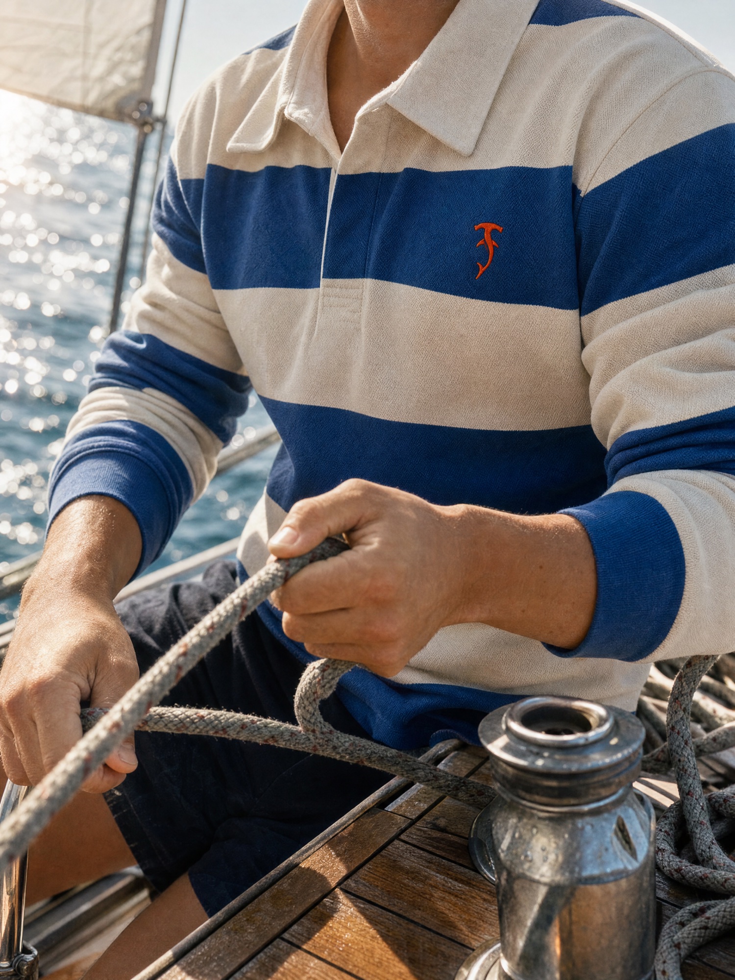 Tirreno striped rugby shirt worn while working a sailboat line